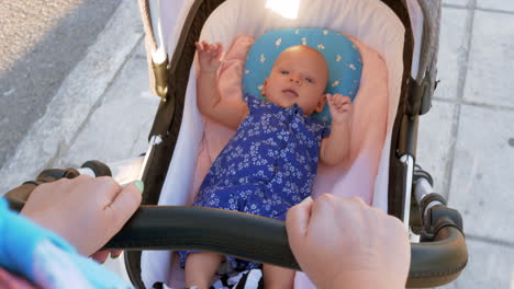 Mother-with-baby-carriage-walking-in-the-street