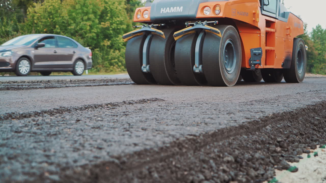 Road roller in work on the road. Close up view of road roller repairing asphalt pavement
