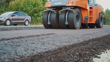 road roller in work on the road. close up view of road roller repairing asphalt pavement