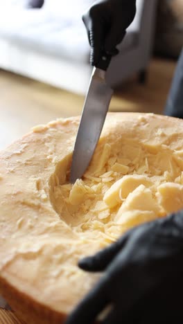 cortando una rueda de queso parmesano