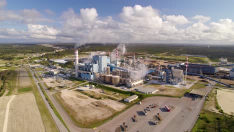 Aerial-wide-shot-of-a-big-industrial-plant-on-a-sunny-day---bird's-eye-view-of-a-modern-cellulose-factory-in-Portugal