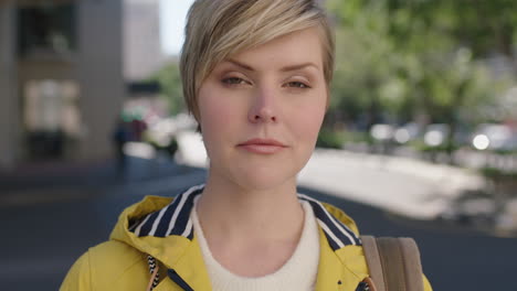 portrait of serious blonde woman looking pensive at camera wearing yellow jacket