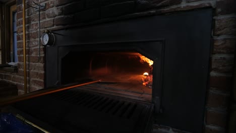 wood fire oven being prepped for baking traditional italian pizza