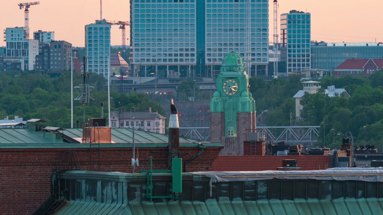 Time-lapse of Helsinki Central Railway Station clock tower and Pasila at dawn