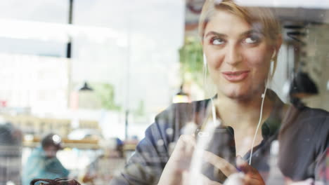 Beautiful-woman-video-messaging-conference-call-tablet-in-cafe