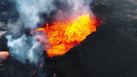 Close-up-aerial-view-over-the-volcanic-eruption-at-Litli-Hrutur,-Iceland,-with-fresh-lava-and-smoke-coming-out