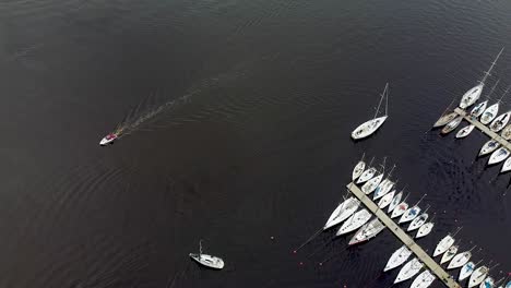 Aerial-of-a-small-boat-and-a-sailing-boat-next-to-Parnu-harbour-in-Estonia-during-summer