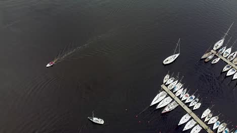 aerial of a small boat and a sailing boat next to parnu harbour in estonia during summer