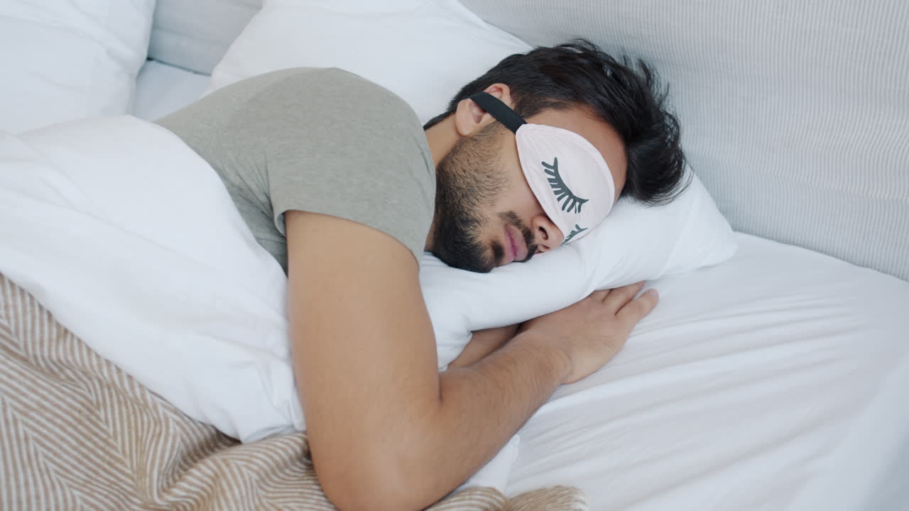 Man Sleeping in Bed with Eye Mask