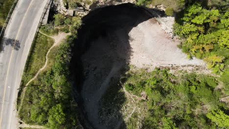 aerial circle top down shot of famous devil's punch bowl in canadian ontario during summer day