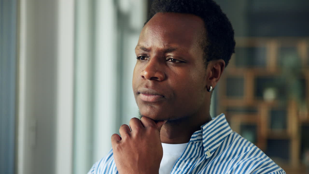 Young Black Man Thinking Deeply with Pensive Expression