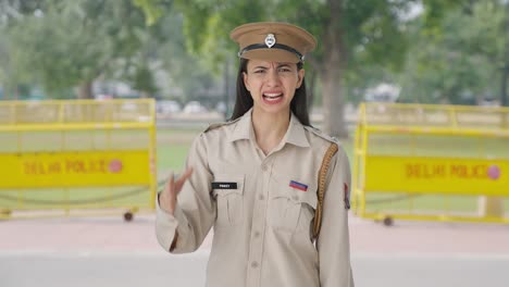 angry indian female police officer shouting on someone