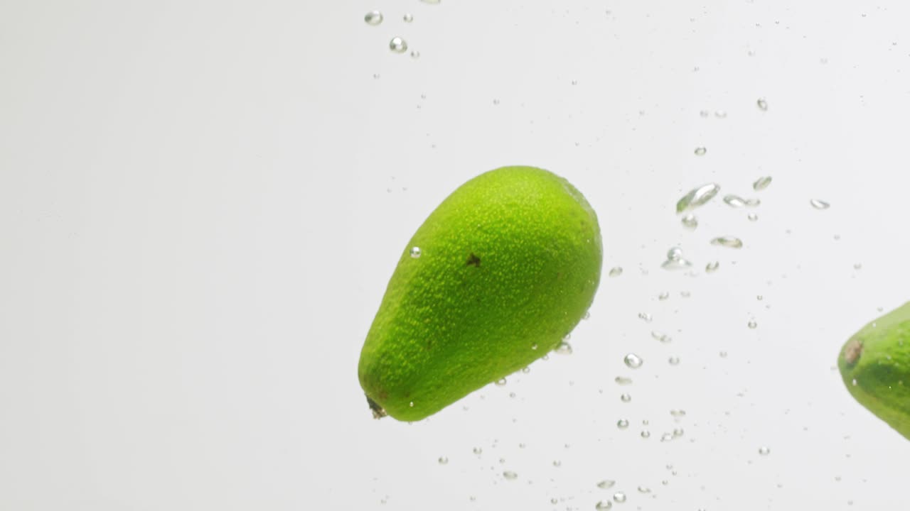 Avocados Splashing in Water