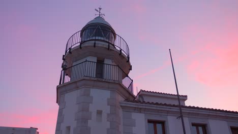 low angle shot of tall peniscola lighthouse in the heart of the old town near mediterranean sea in castellon, spain during evening time