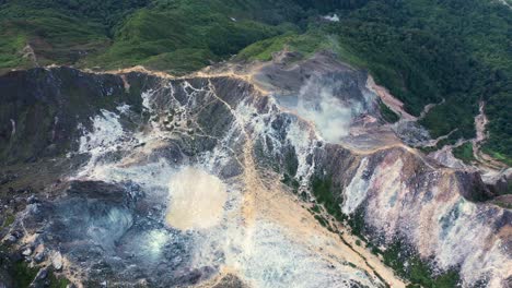 aerial view above dramatic crater lake in stratovolcano mount sibayak in north sumatra, indonesia