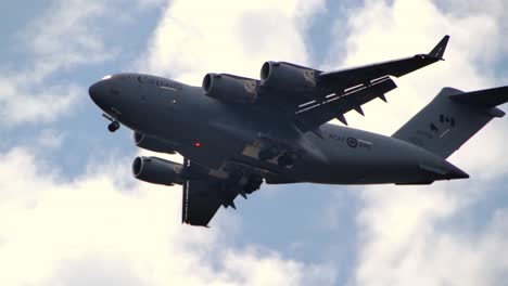 tracking shot of overflying rcaf c-17 globemaster iii cargo plane