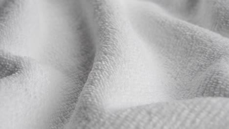 microfiber cloth. cleaning fiber napkin. crumpled white fibre towel. gray cleaning rag surface