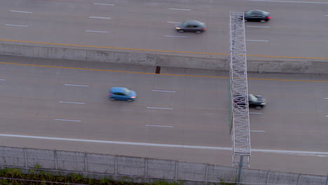 aerial overhead view of cars on a highway in the evening with a tilt up and down