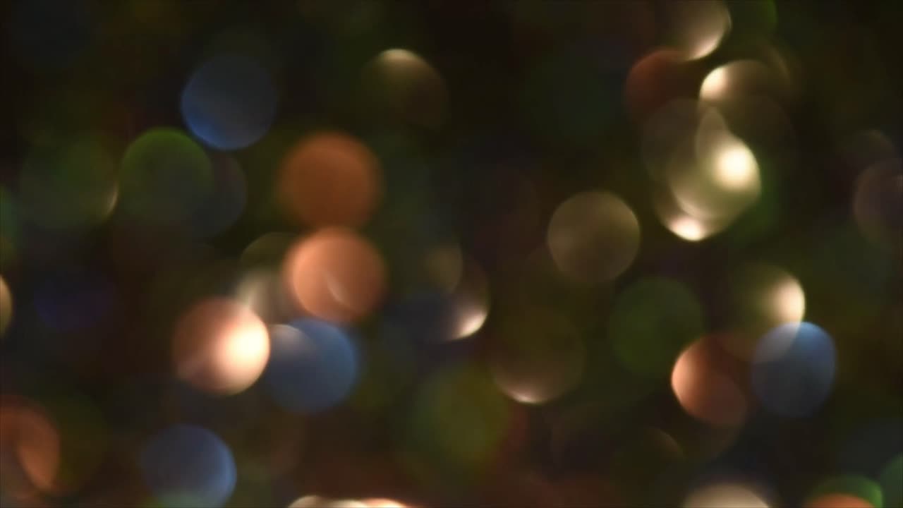 Luci Bokeh Colorate Dinamiche Scintillanti su Sfondo Scuro