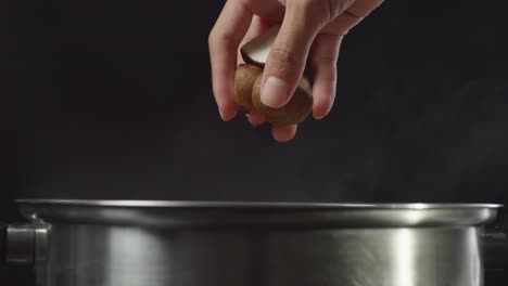 adding mushrooms and spices to a pot