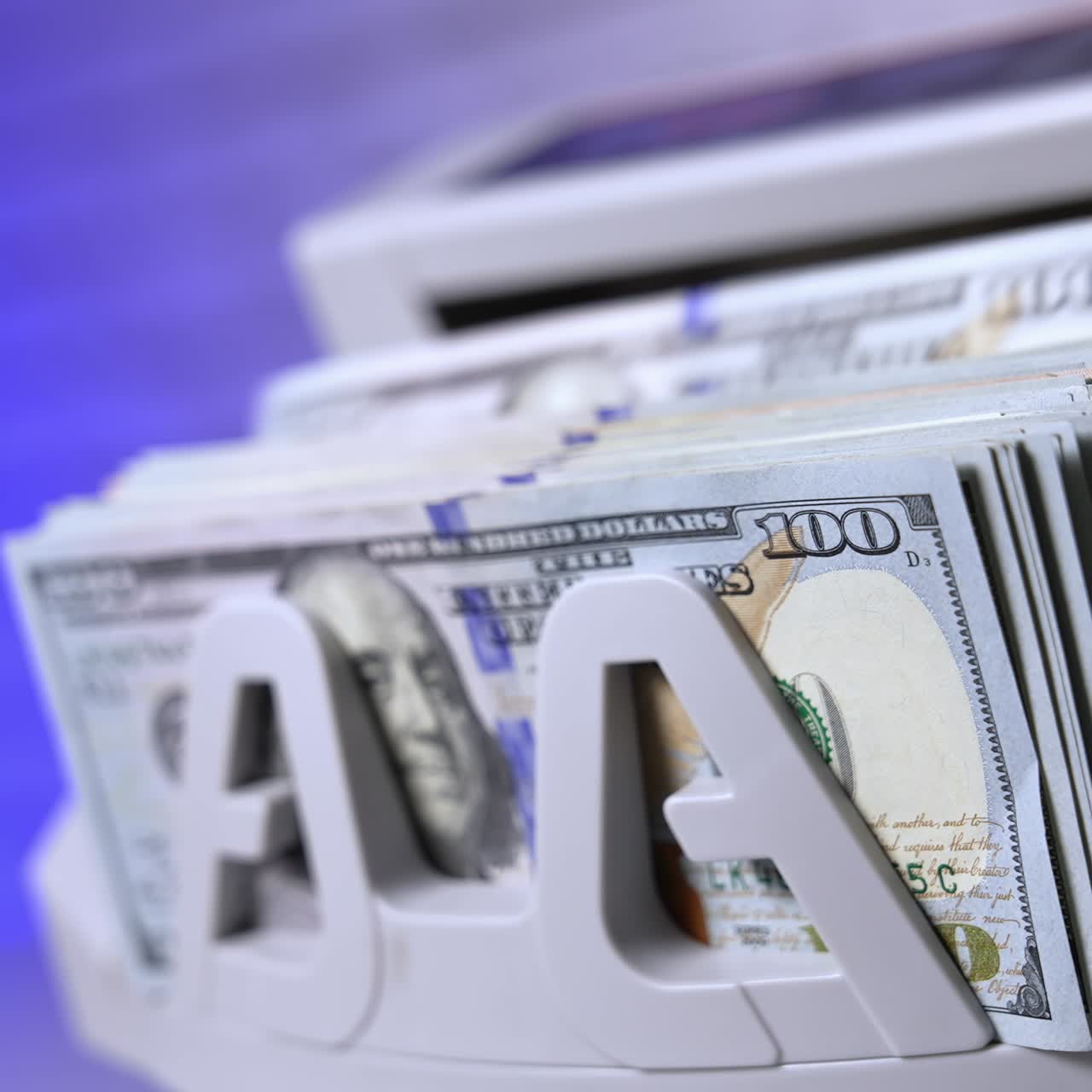 Counting hundred of dollar bills in bank. Financial operation on a modern electronic cash counting machine. Automatic equipment for counting paper money