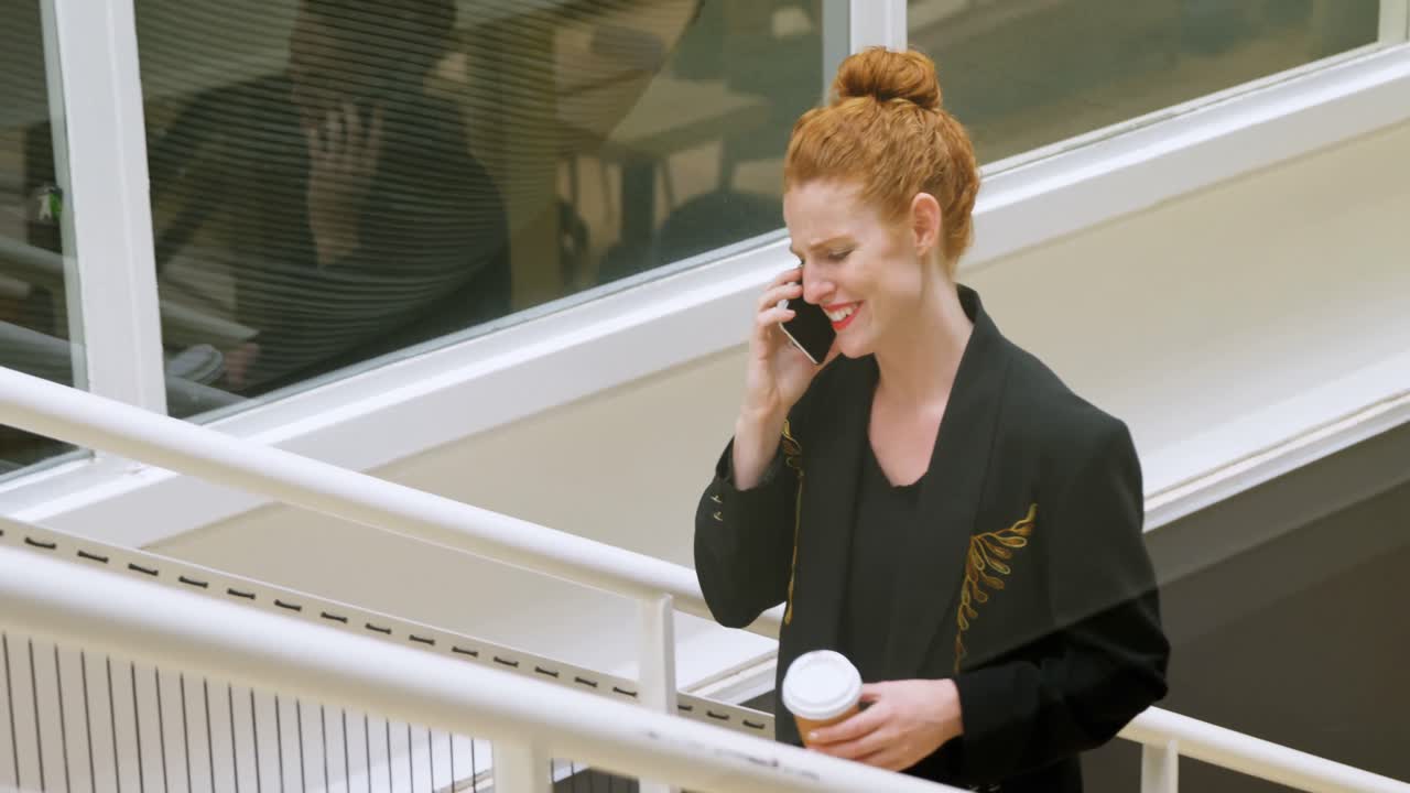 4k 위층으로 이동하는 동안 휴대 전화를 사용하는 사업가