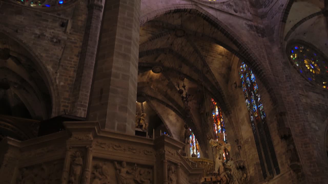 Female Tourist Appreciating Cathedral Architecture Pan Up to Ceiling With Stained Glass Windows