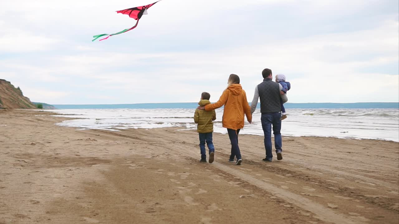 Family enjoying a day at the beach with a kite