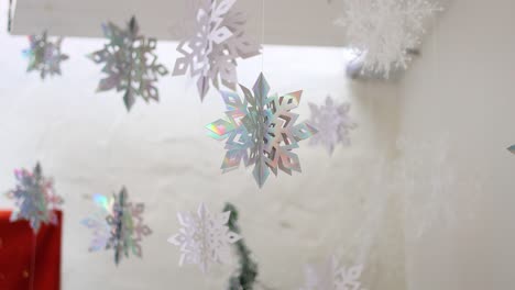 paper snowflakes descending against a white backdrop