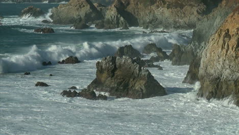 surf powered by a winter storm rolls into the big sur coastline of california