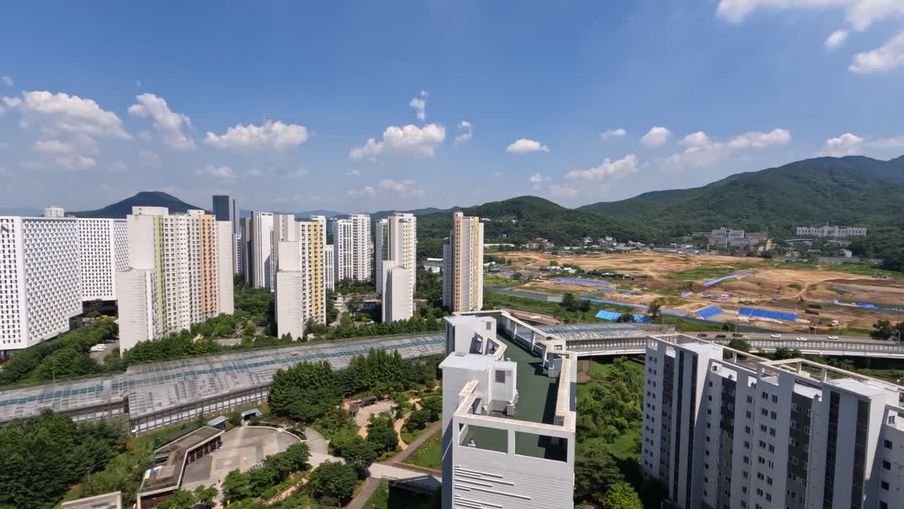 Daytime time-lapse of Seocho Hills and Nature Hills Apartments with scenic skyline, green hills, and blue sky in Seoul