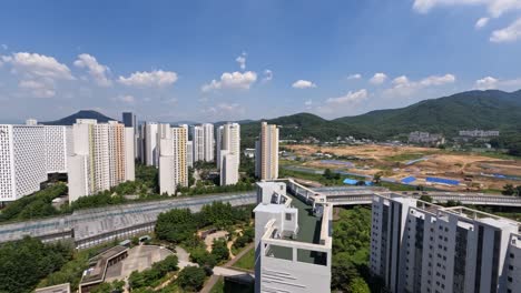 daytime time-lapse of seocho hills and nature hills apartments with scenic skyline, green hills, and blue sky in seoul