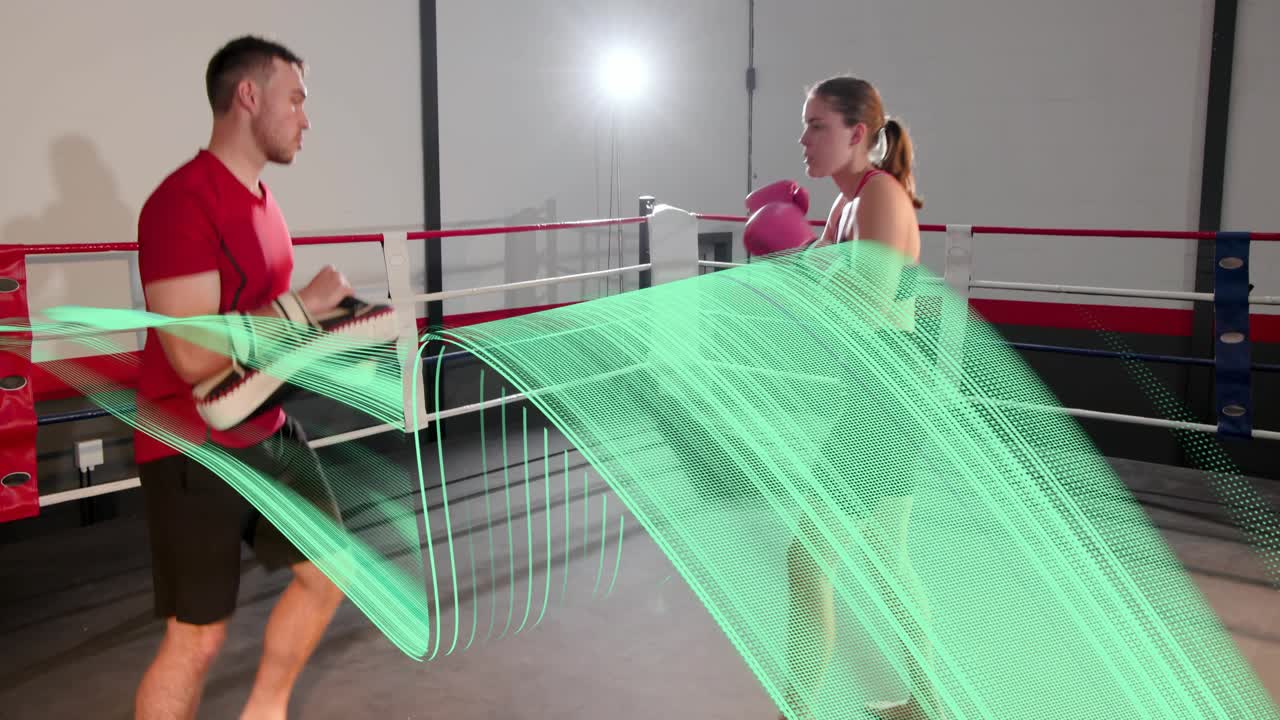 Trainer holding pads cueing trainee striking, boxing drills with green trail tracing motion