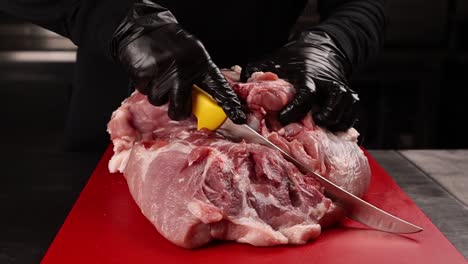 chef boning raw pork loin