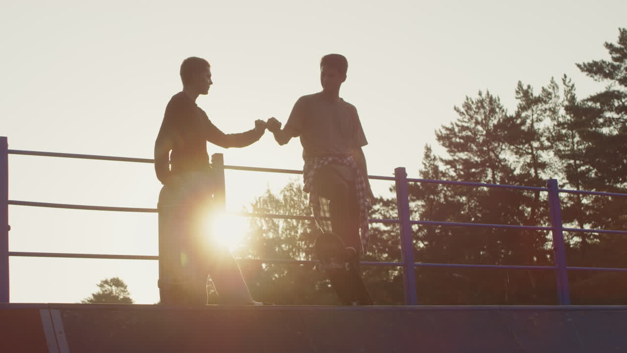 Guys with Skateboards Fist Bumping