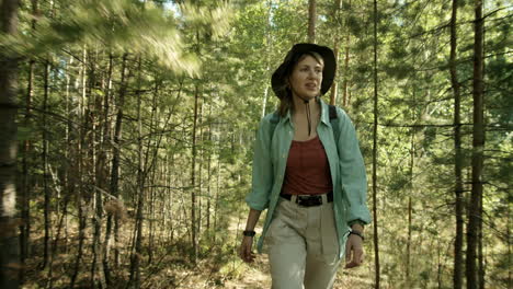 Female-Hiker-Walking-with-Dog-through-Forest