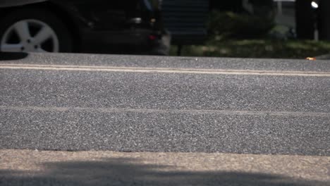 low angle view of cars driving on asphalt road during daytime