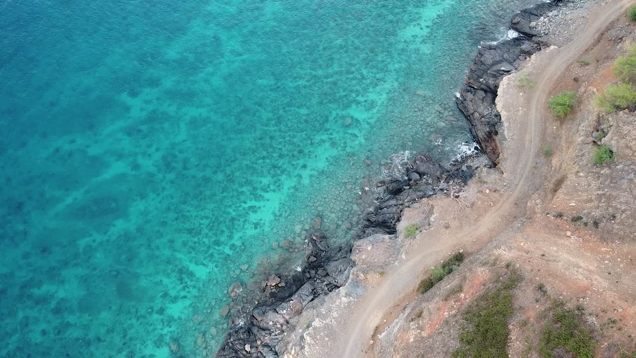 Aerial birds eye view of coastal landscape with turquoise ocean water and waves on tropical island of Timor-Leste, Southeast Asia