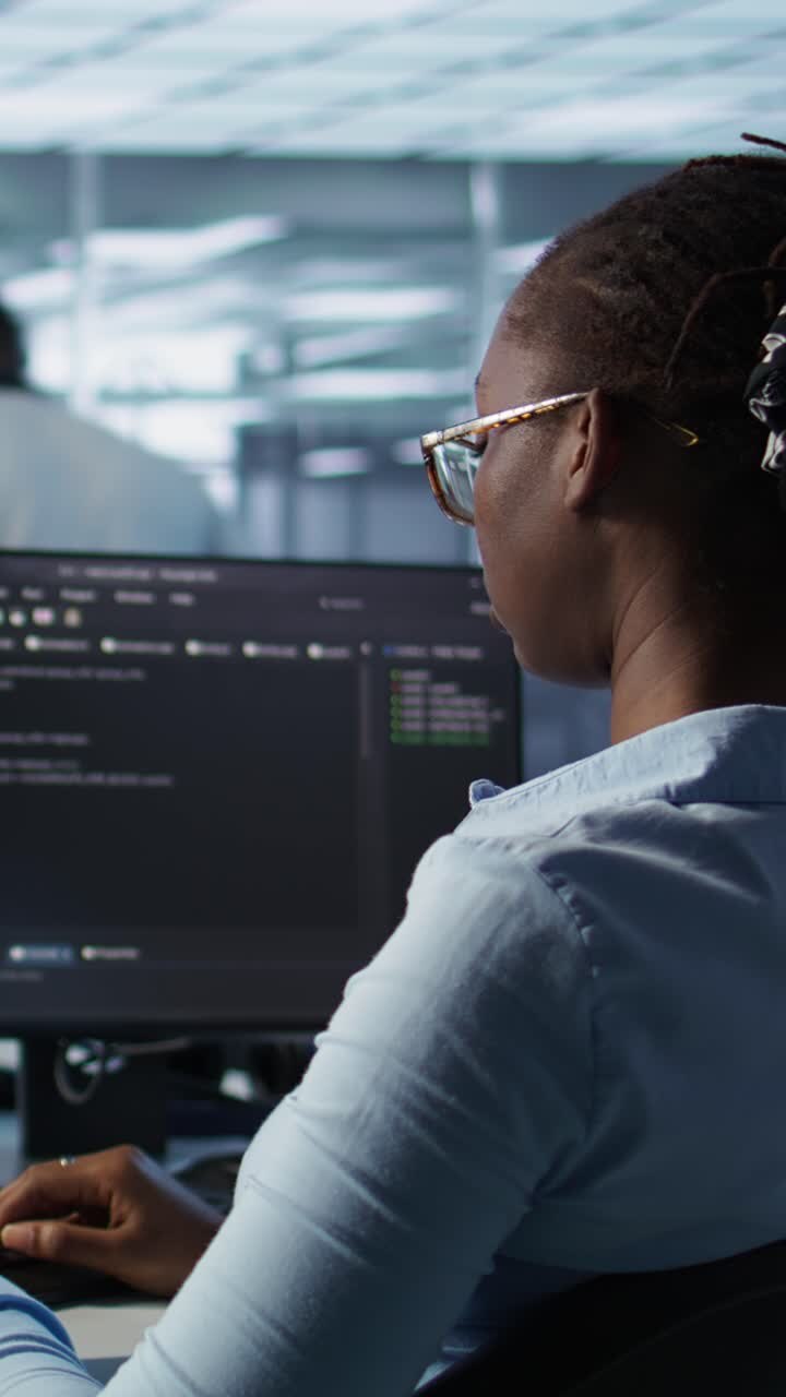 African American Woman Programmer Typing Code on Computer in Office