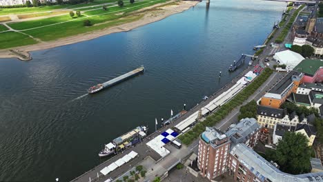 cargo vessel travelling along the river rhine, düsseldorf, germany