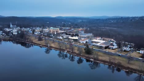 aerial footage approaching a small lake town in america just after sunset