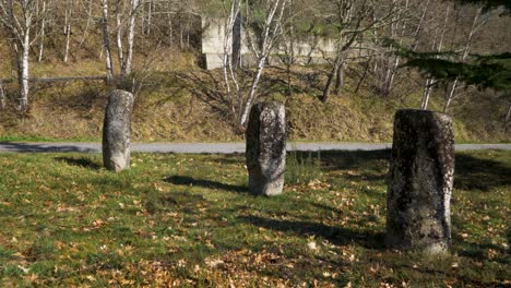 ancient granite roman milestone markers next to empty road