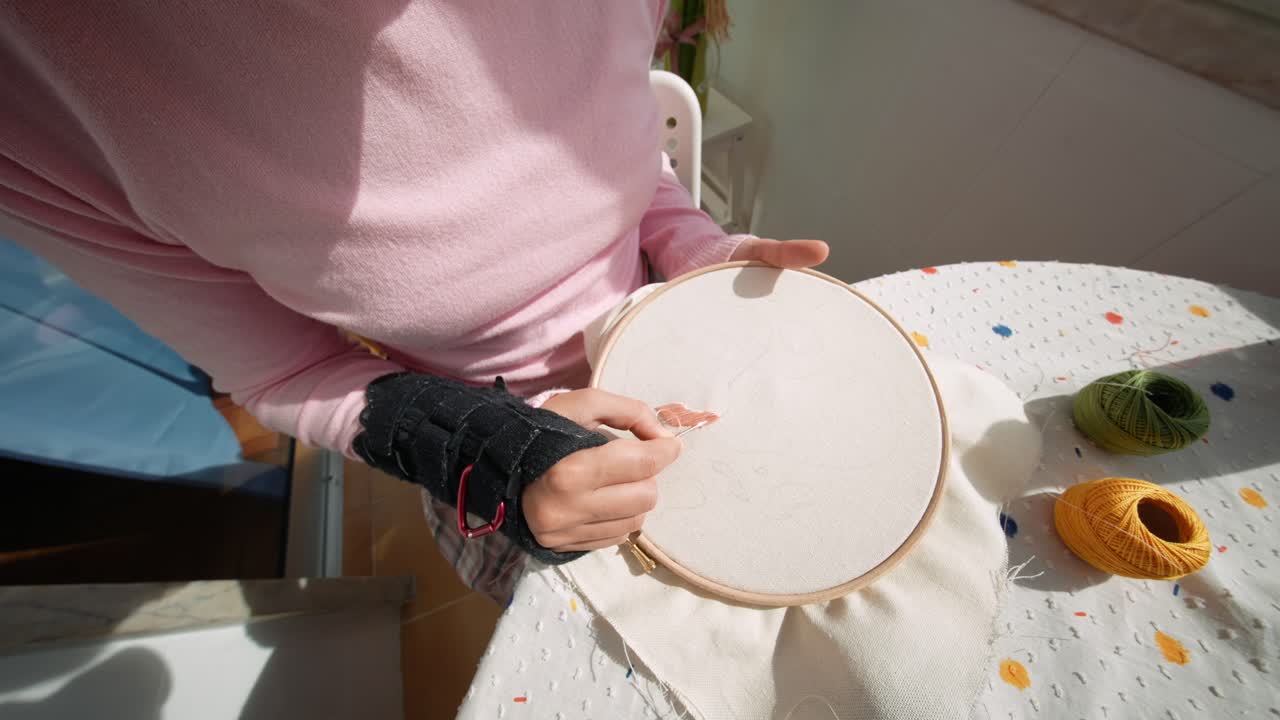 Woman's Hands Embroidering Fabric with Needle and Thread