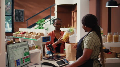 local vendor scanning jars of organic homemade sauces