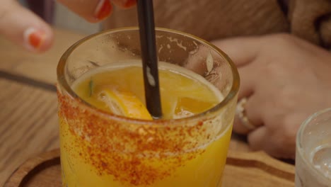 woman enjoying an orange juice cocktail