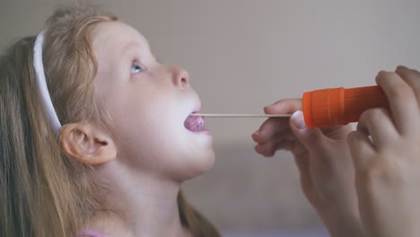 woman-tries-to-check-throat-with-wooden-tongue-depressor