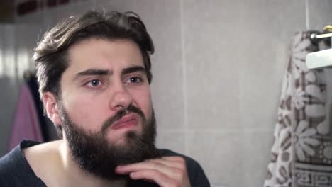 man checking his appearance in a bathroom mirror