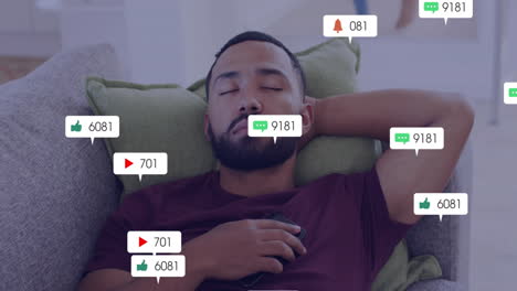 Relaxing on couch, man watching animation of social media notifications floating