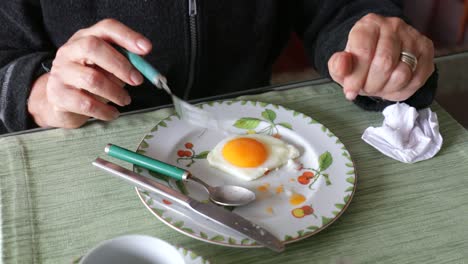 person eating breakfast in the morning, fried egg