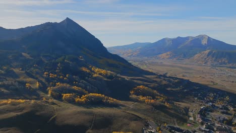 mount crested butte ski resort mountain town vibrant thick full aspen trees fall autumn auburn peak colors aerial drone colorado morning kebler pass gunnison national forest sunny bluesky circle left